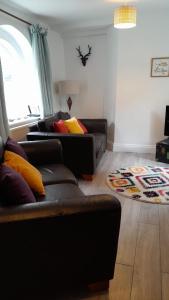 a living room with two couches and a table at Vavasour at The Red House Estate in York