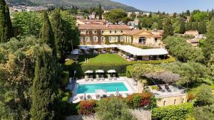 an aerial view of a mansion with a swimming pool at Bastide Saint Antoine - Relais & Châteaux in Grasse