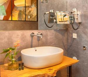a bathroom with a white sink on a wooden table at Boutique Hotel, Restaurant & Wellness Westerburcht in Westerbork +41 photos