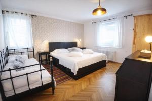 a bedroom with two beds and a couch at Apartments Poldi in Bled