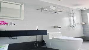 a bathroom with a toilet and a sink and a mirror at Ruby Homestay in Cam Lâm +42 photos