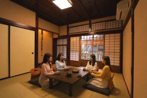 a group of women sitting around a table in a room at 龍助25 Ryusuke25 in Komatsu