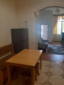 a living room with a wooden table in a room at Guest house in Jermuk +9 photos