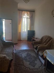 a living room with two couches and a rug at Guest house in Jermuk