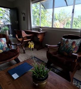 a living room with chairs and a coffee table and a tableablish at The Loft in Mtunzini +34 photos