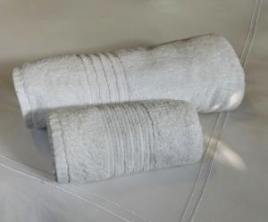 a roll of white towels hanging on a wall at The Loft in Mtunzini