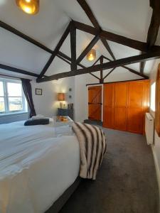 a bedroom with a large white bed in a room at Vavasour at The Red House Estate in York +20 photos
