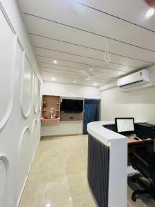 an office with a desk and a computer in a room at Hotel Sulin Prahladnagar in Ahmedabad