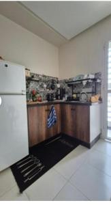 a kitchen with a refrigerator and a counter top at Duplex al menzah in Tamaris +14 photos