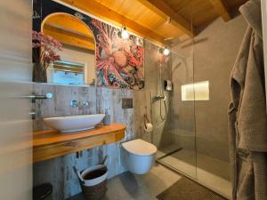 a bathroom with a toilet and a sink and a shower at Casa do Barco in Odiáxere +19 photos