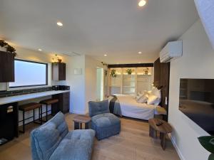 a hotel room with a bed and a kitchen at The Old Tin Shed in Wanaka