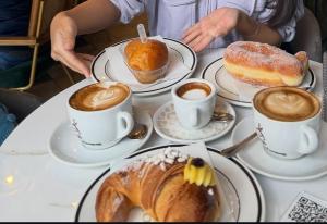 a table topped with cups of coffee and pastries at A 100 passi dal mare in Bari