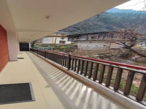 a balcony of a building with a view of a mountain at Woodward 2 by 4 Wildflower in Kasol