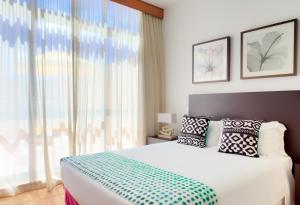 Postel nebo postele na pokoji v ubytování Hotel Torre Praia