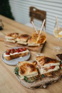 a group of sandwiches on plates on a wooden table at Maison Kounic Palace Suites in Slavkov u Brna