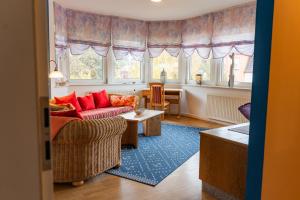 a living room with a couch and a table at Pension Herkules in Koserow