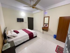 a bedroom with a bed and a television in it at Sky n Valley in Bāndarban