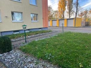 a building with two parking meters in the grass at Appartement am Löhner Bahnhof in Löhne