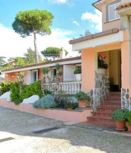 a house with some plants in front of it at Villa D Holiday Homes Castelli Romani in Marino