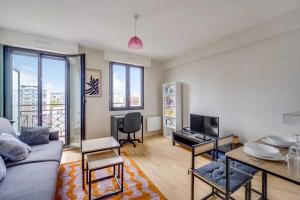 a living room with a couch and a table at Spacious Studio 2P - Near La Défense in Courbevoie