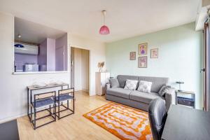 a living room with a couch and a table at Spacious Studio 2P - Near La Défense in Courbevoie