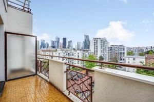 a balcony with a view of a city at Spacious Studio 2P - Near La Défense in Courbevoie