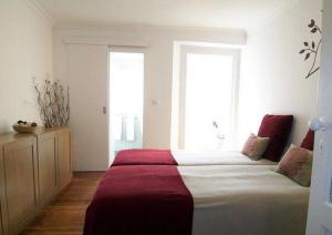 a bedroom with a large bed and a window at Estrela Cozy Apartment in Lisbon