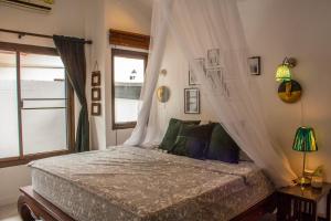 a bedroom with a bed with curtains and a window at Southern Lanta C9 in Ko Lanta +18 photos