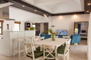 a dining room with a white table and chairs at Southern Lanta C9 in Ko Lanta
