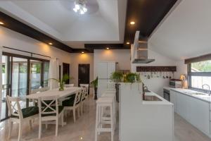 a kitchen with a table and chairs in a kitchen at Southern Lanta C9 in Ko Lanta