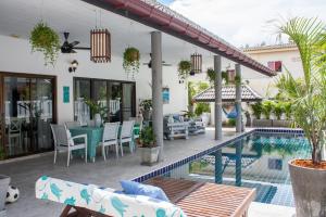 a house with a swimming pool and a patio at Southern Lanta C9 in Ko Lanta