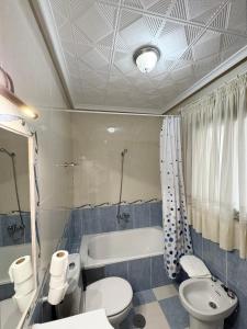 a bathroom with a tub and a toilet and a sink at Hidalgo in Alcaudete +73 photos