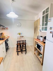 a kitchen with a table and two stools in it at casa rústica Ronda in Ronda +31 photos