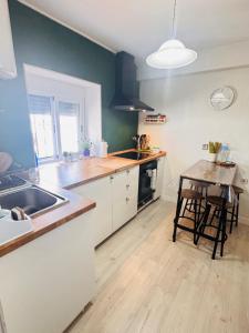 a kitchen with a sink and a table in it at casa rústica Ronda in Ronda