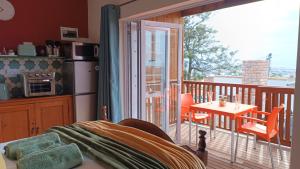 a bedroom with a balcony with a table and chairs at 27 on Brunswick in Gqeberha