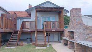 a house with a staircase leading to a deck at 27 on Brunswick in Gqeberha