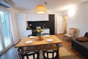 a kitchen and dining room with a wooden table and chairs at Apartments Poldi in Bled