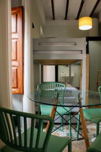 a dining room with a glass table and chairs at La Casa del Médico in Pego