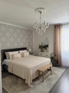 a bedroom with a large bed and a chandelier at Rooms Zana in Split