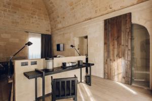a room with a table and two lamps on the wall at Il Palazzotto I Residence & Winery in Matera +76 photos