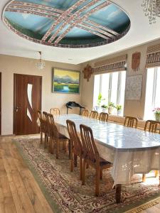 a dining room with a large table and chairs at Tumar guest house, Kochkor in Kochkorka
