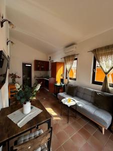 a living room with a couch and a table at Kuca Mir Seaside Apartments - 50m from Beach in Ugljan
