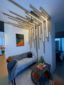 a living room with a couch and a table at Pool View Studio Apartment Caesar Resort & Spa in Dherinia +26 photos