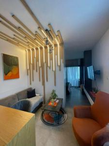 a living room with a couch and a table at Pool View Studio Apartment Caesar Resort & Spa in Dherinia
