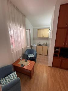 a living room with a couch and a table at Guest House Garden in Budva