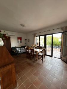 a living room with a table and chairs and a couch at Kuca Mir Seaside Apartments - 50m from Beach in Ugljan