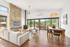 a living room with a couch and a table and a fireplace at Bright Vista with Studio in Bright