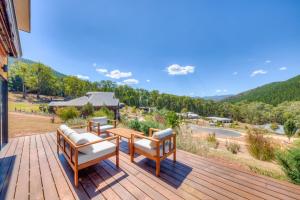 a deck with two chairs and a table with a view at Bright Vista with Studio in Bright