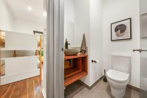 a bathroom with a toilet and a sink at Bright Vista with Studio in Bright +14 photos