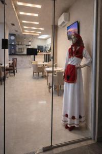a statue of a woman in a dress in a room at Hotel Capital Inn Tirana by Arta in Tirana